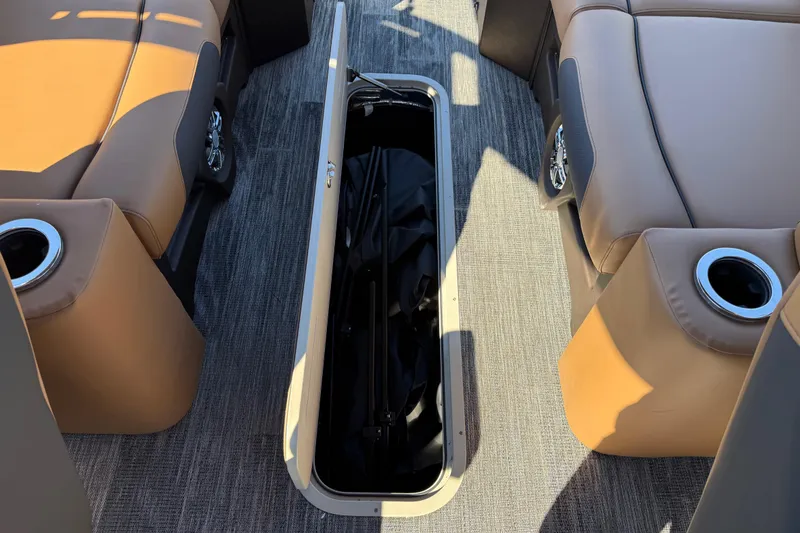 Slide: The Image of 2026 Avalon Catalina Quad Lounger Windshield interior with open storage compartment. - 65