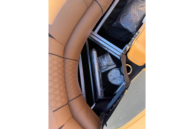 Slide: The Image of 2026 Avalon Catalina Quad Lounger Windshield interior storage compartment with tan upholstery. - 72