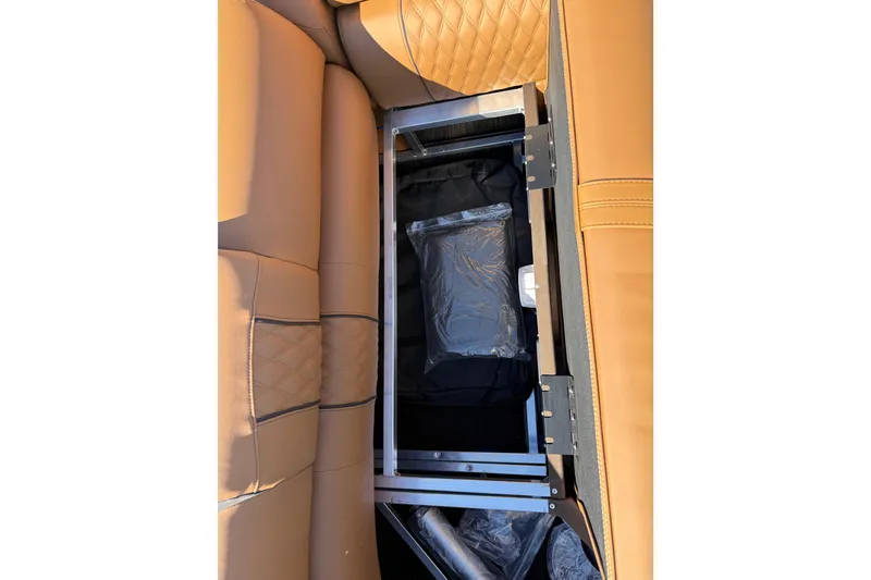 Slide: The Image of 2026 Avalon Catalina Quad Lounger Windshield with tan leather seating and storage compartment. - 73