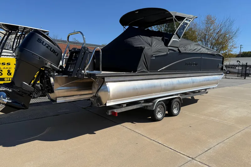 Slide: The Image of 2026 Avalon Catalina Quad Lounger Windshield boat on trailer with Suzuki outboard motor. - 8