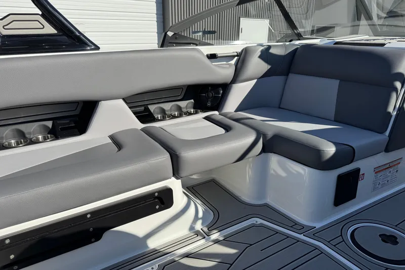 Slide: The Image of 2026 Moomba Craz boat interior with gray seating and cup holders. - 11