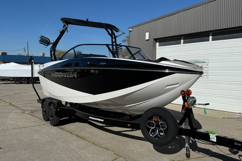 Slide: The Image of 2026 Moomba Craz boat on trailer, black and white design, parked outdoors. - 3