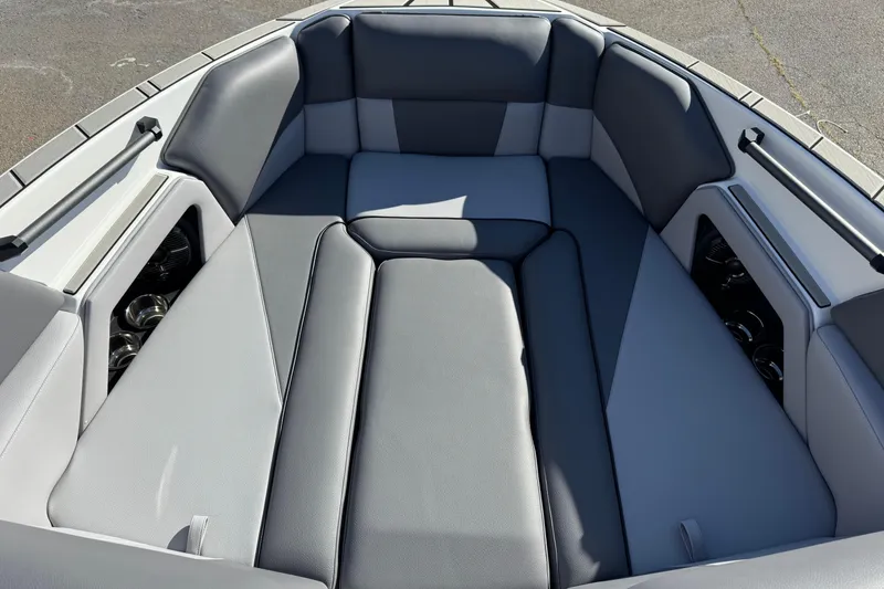 Slide: The Image of 2026 Moomba Craz boat interior with gray cushioned seating and cup holders. - 6