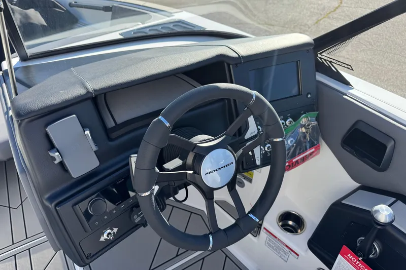 Slide: The Image of 2026 Moomba Craz boat dashboard with steering wheel and control panel. - 9