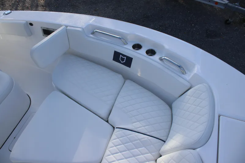 Slide: The Image of 2026 Sea Fox 248 Commander boat with white cushioned seating and cup holders. - 13