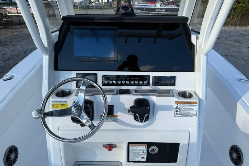 Slide: The Image of 2026 Sea Fox 248 Commander boat dashboard with steering wheel and control panel. - 16