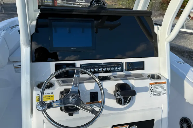 Slide: The Image of 2026 Sea Fox 248 Commander boat dashboard with steering wheel and navigation controls. - 17