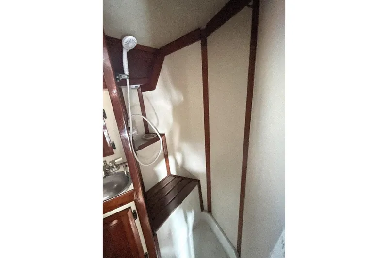 Slide: The Image of Interior of 1986 Ericson 381 sailboat with wood finish and cozy seating area. - 13