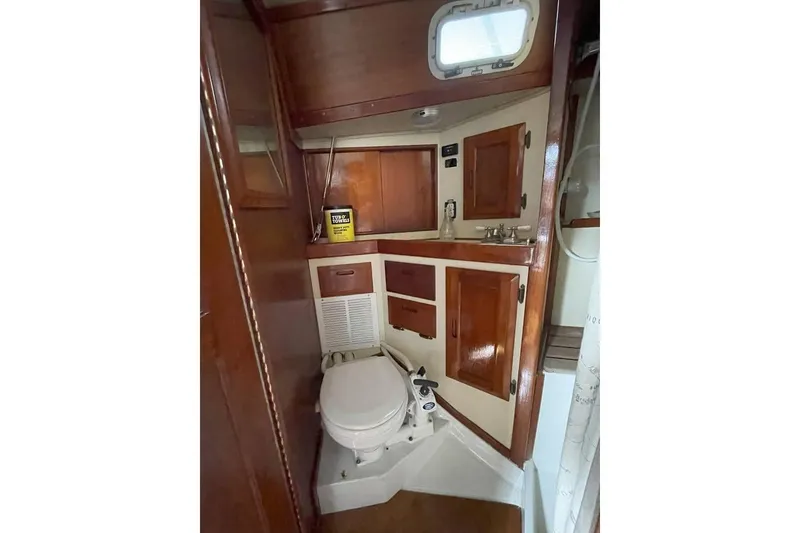 Slide: The Image of Interior of 1986 Ericson 381 sailboat with wood finish and seating area. - 14