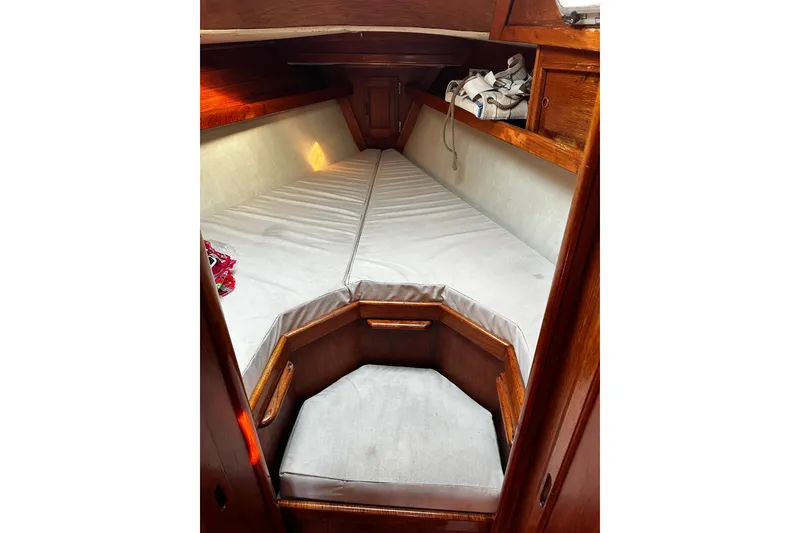 Slide: The Image of Cozy cabin interior of 1986 Ericson 381 sailboat with wooden finish and cushioned seating. - 22
