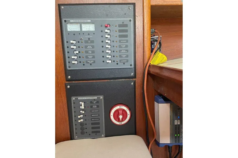 Slide: The Image of Electrical control panel on a 1986 Ericson 381 sailboat, featuring switches and gauges. - 24