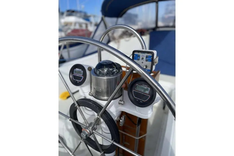 Slide: The Image of Sailboat Ericson 381, 1986 model, docked at marina with clear blue sky. - 3