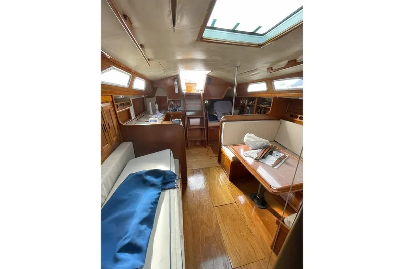 Slide: The Image of 1986 Ericson 381 sailboat named "Momentum" docked in a marina. - 5