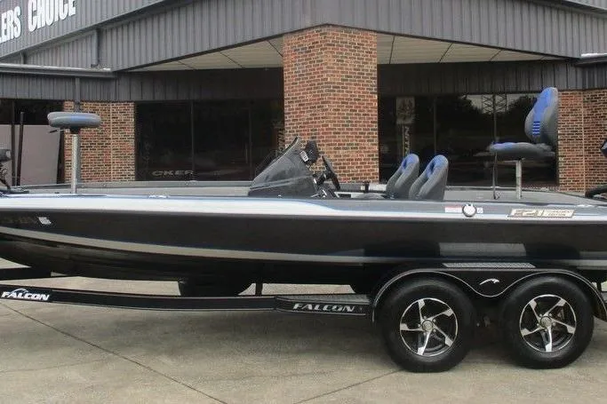 The Image of 2021 Falcon F21 boat with sleek design, parked on a trailer outside a building. - 0