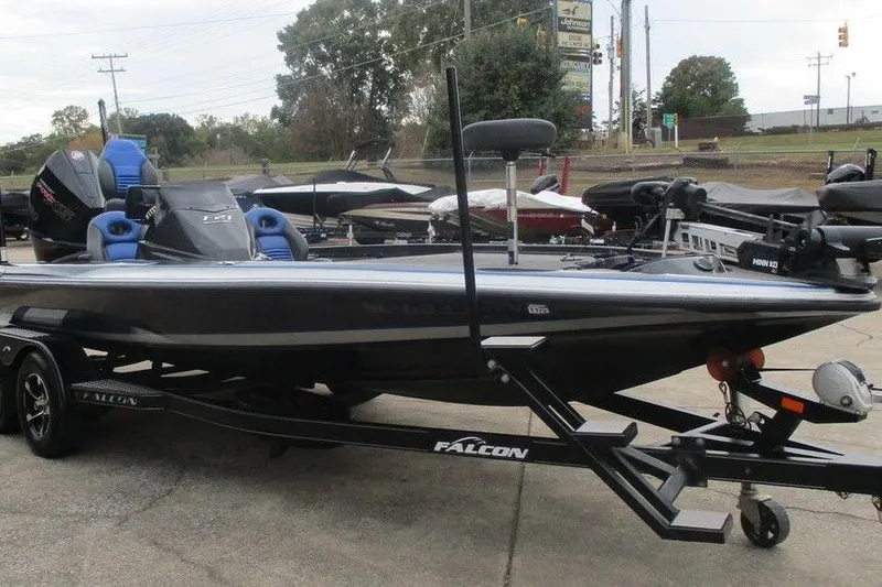 Slide: The Image of 2021 Falcon F21 boat on trailer, featuring sleek design and blue seating. - 3