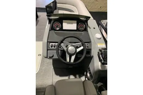 Slide: The Image of 2025 Godfrey Monaco 235 SD boat dashboard with steering wheel and controls. - 10