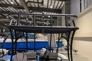 Slide: The Image of 2025 Godfrey Monaco 235 SD boat displayed indoors, showcasing upper deck and seating area. - 6