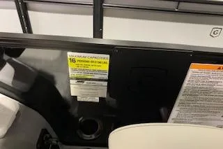 Slide: The Image of 2025 Godfrey Monaco 235 SD boat interior with capacity warning label. - 9