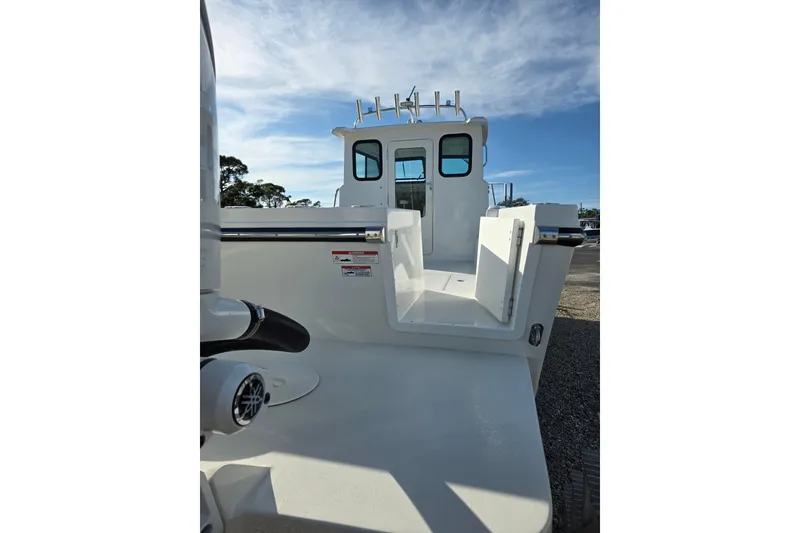 Slide: The Image of 2026 Parker 247 Explorer boat, rear view with open deck and clear sky. - 14