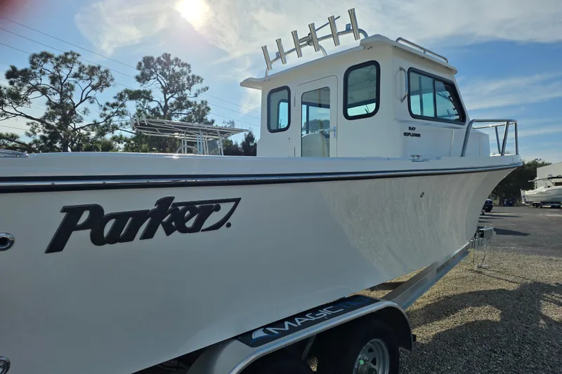 Slide: The Image of 2026 Parker 247 Explorer boat on trailer under sunny sky. - 15
