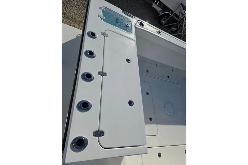 Slide: The Image of 2026 Parker 247 Explorer boat deck with rod holders and storage compartments. - 16