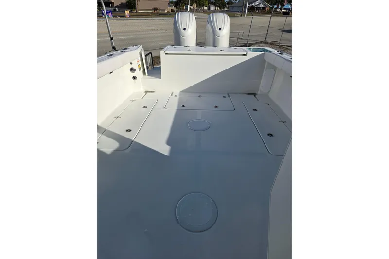 Slide: The Image of 2026 Parker 247 Explorer boat deck with storage compartments and dual engines. - 18