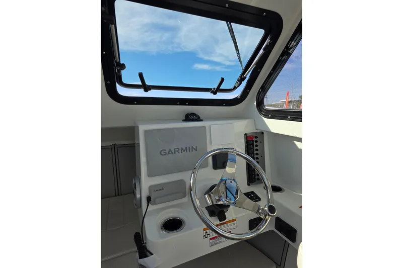 Slide: The Image of Interior view of 2026 Parker 247 Explorer boat cockpit with Garmin navigation system. - 19