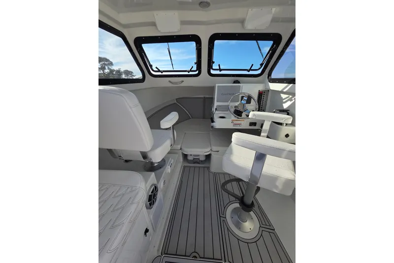 Slide: The Image of Interior of 2026 Parker 247 Explorer boat with modern helm and seating. - 21