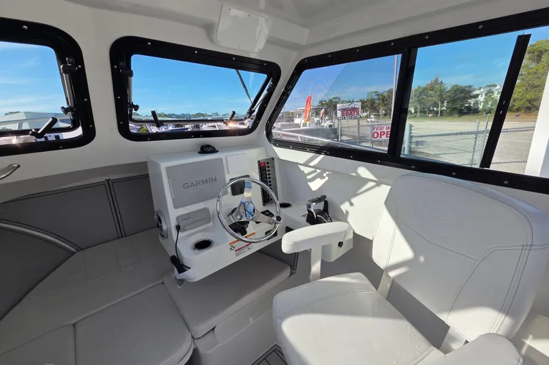 Slide: The Image of Interior of 2026 Parker 247 Explorer boat with Garmin navigation system and seating. - 24