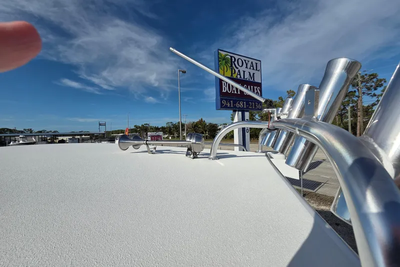 Slide: The Image of 2026 Parker 247 Explorer boat at Royal Palm Boat Sales under clear blue sky. - 28