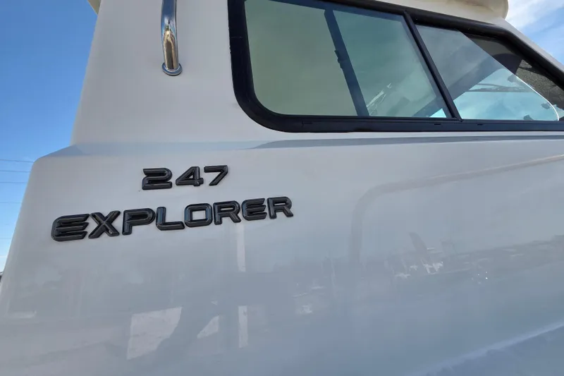 Slide: The Image of 2026 Parker 247 Explorer boat side view with model name and window. - 31