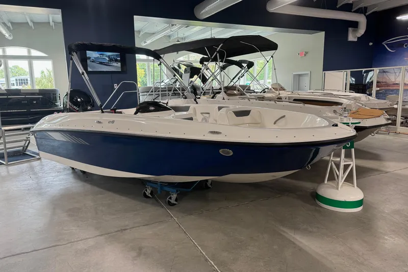 The Image of 2026 Bayliner Element E18 boat displayed in a showroom with other boats. - 1