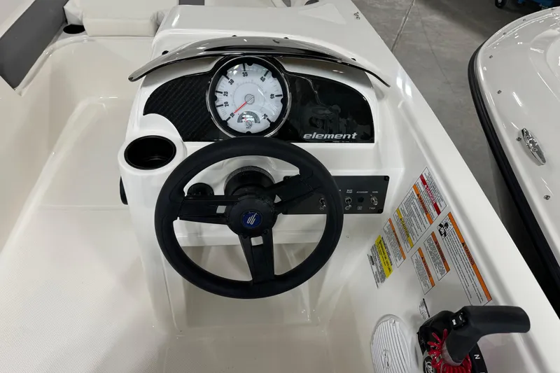 Slide: The Image of 2026 Bayliner Element E18 boat dashboard with steering wheel and gauges. - 14
