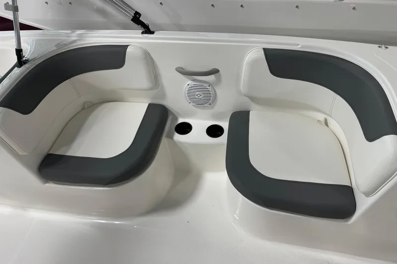 Slide: The Image of 2026 Bayliner Element E18 boat seating area with cup holders and speaker. - 8