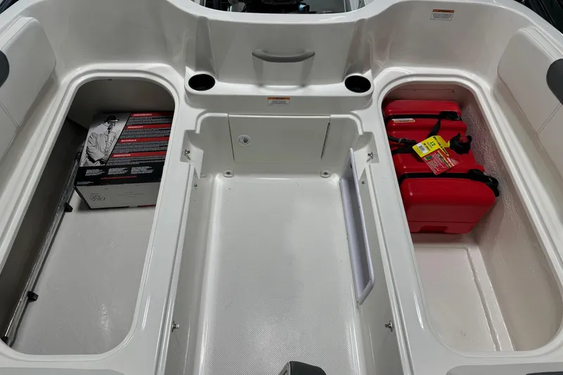 Slide: The Image of 2025 Bayliner Element E18 boat storage compartments with red fuel tanks and additional storage space. - 17