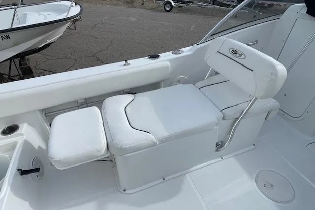 Slide: The Image of 2016 Seahunt 235 Escape DC boat interior with white cushioned seating. - 19