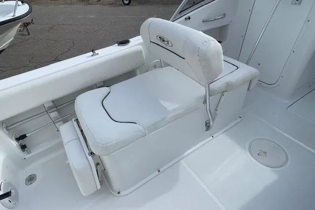 Slide: The Image of 2016 Seahunt 235 Escape DC boat interior with white seating and storage. - 20