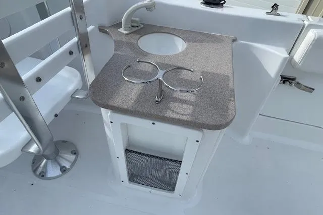 Slide: The Image of 2016 Seahunt 235 Escape DC boat sink and countertop with cup holders. - 26