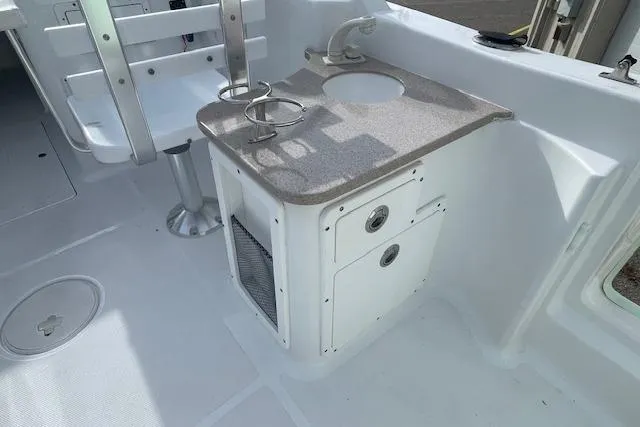 Slide: The Image of 2016 Seahunt 235 Escape DC boat interior with sink and storage area. - 27