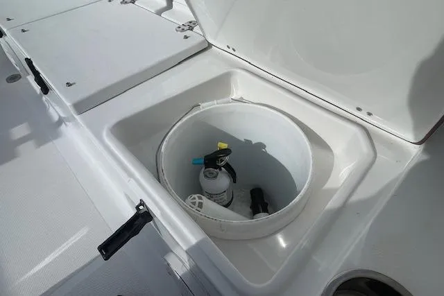 Slide: The Image of Open storage compartment on 2016 Seahunt 235 Escape DC boat. - 33