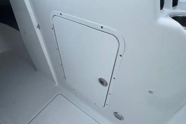 Slide: The Image of 2016 Seahunt 235 Escape DC boat interior storage compartment door. - 36