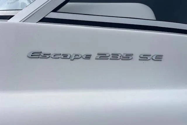 Slide: The Image of 2016 Seahunt 235 Escape DC boat model nameplate on white surface. - 7