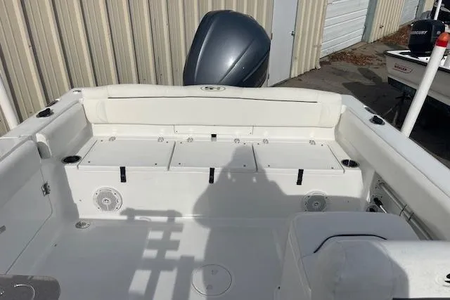 Slide: The Image of 2016 Seahunt 235 Escape DC boat interior with seating and storage compartments. - 8