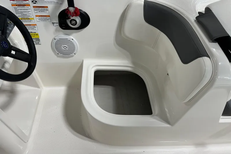Slide: The Image of 2025 Bayliner Element E18 boat interior with steering wheel and storage compartment. - 13