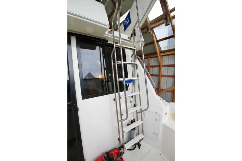 Slide: The Image of 1998 Bayliner 3788 Command Bridge Motoryacht ladder and deck area. - 12
