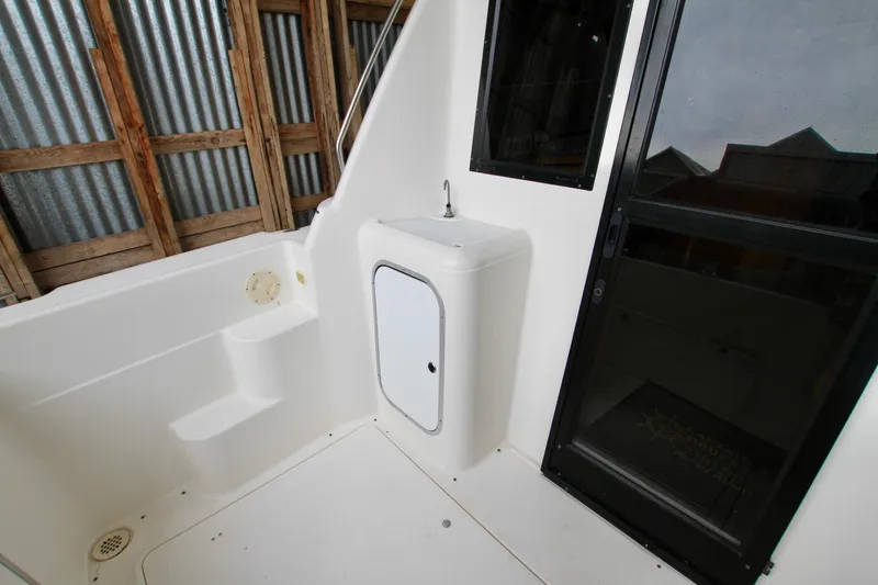 Slide: The Image of 1998 Bayliner 3788 Command Bridge Motoryacht interior with sink and sliding door. - 13