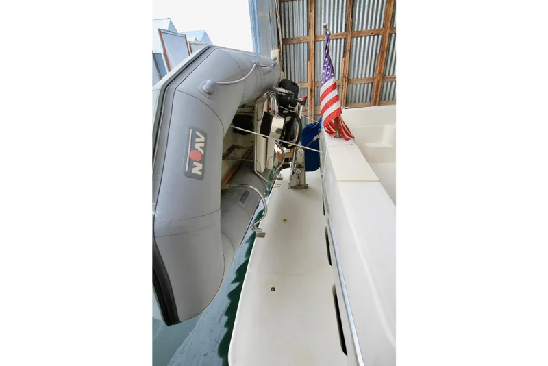 Slide: The Image of 1998 Bayliner 3788 Command Bridge Motoryacht with covered outboard motor and docked accessories. - 15