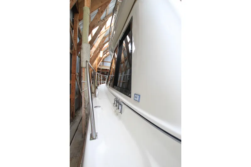 Slide: The Image of 1998 Bayliner 3788 Command Bridge Motoryacht storage area with equipment and blue folding chair. - 21