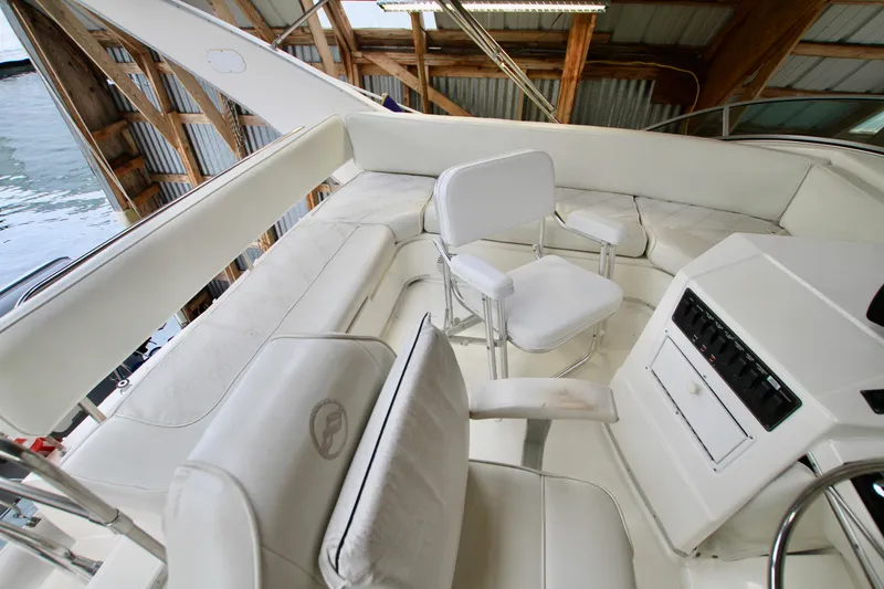 Slide: The Image of 1998 Bayliner 3788 Command Bridge Motoryacht side view in a wooden boathouse. - 26