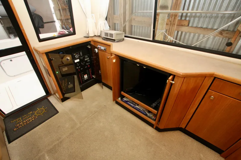 Slide: The Image of 1998 Bayliner 3788 Command Bridge Motoryacht in a wooden boathouse with tools and equipment. - 29